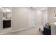 Hallway with carpet, a bench, and access to a bathroom at 7203 Sweet Alyssum Ct, Tampa, FL 33619