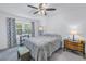 Bright bedroom with a double bed, ceiling fan, and ample natural light at 6400 46Th N Ave # 117, Kenneth City, FL 33709