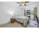 Cozy bedroom featuring a bed, ceiling fan, and built-in shelving at 6400 46Th N Ave # 117, Kenneth City, FL 33709