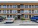 Condo building exterior with parking and entrance at 6400 46Th N Ave # 117, Kenneth City, FL 33709