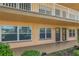 Exterior view of condo building showcasing two unit entrances with doors and windows at 6400 46Th N Ave # 117, Kenneth City, FL 33709