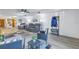 Living room with gray sofa, wicker chairs, and area rug at 6400 46Th N Ave # 117, Kenneth City, FL 33709