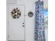 Condo entryway with white door, wreath, and floral curtains at 6400 46Th N Ave # 117, Kenneth City, FL 33709