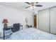 Bedroom with ceiling fan, built-in shelving, and desk at 6400 46Th N Ave # 117, Kenneth City, FL 33709