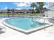 Community pool with surrounding patio and lounge chairs at 6400 46Th N Ave # 117, Kenneth City, FL 33709