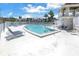 Relaxing kidney-shaped pool with lounge chairs and patio area at 6400 46Th N Ave # 117, Kenneth City, FL 33709