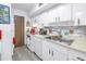 White kitchen with double sink and dishwasher at 6400 46Th N Ave # 117, Kenneth City, FL 33709