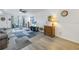 Living room with gray sofa, wicker chairs, and area rug at 6400 46Th N Ave # 117, Kenneth City, FL 33709