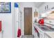 Galley kitchen with white cabinets and appliances at 6400 46Th N Ave # 117, Kenneth City, FL 33709
