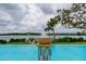 Resort-style pool with fountain and tranquil waterfront view at 2313 Sunset Wind Loop, Oldsmar, FL 34677