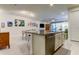Kitchen island with granite countertop, seating, and stainless steel dishwasher at 2313 Sunset Wind Loop, Oldsmar, FL 34677