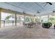 Relaxing poolside patio with tables, chairs, and ceiling fans at 2313 Sunset Wind Loop, Oldsmar, FL 34677