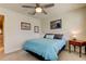 Well-lit bedroom featuring a comfortable bed and wood nightstand at 2313 Sunset Wind Loop, Oldsmar, FL 34677