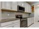 Modern kitchen with grey backsplash and white cabinets at 2313 Sunset Wind Loop, Oldsmar, FL 34677