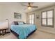 Bright bedroom with a teal comforter, ceiling fan, and window shutters at 2313 Sunset Wind Loop, Oldsmar, FL 34677