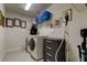 Laundry room with washer, dryer, and extra storage at 2313 Sunset Wind Loop, Oldsmar, FL 34677