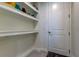 Bright laundry room with built-in shelving and a convenient coat rack at 2313 Sunset Wind Loop, Oldsmar, FL 34677