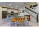 Open kitchen features a granite island and breakfast bar at 2313 Sunset Wind Loop, Oldsmar, FL 34677