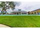 Community pool and cabana with lush green lawn at 2313 Sunset Wind Loop, Oldsmar, FL 34677