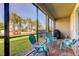 Screened patio with comfortable seating and backyard view at 2313 Sunset Wind Loop, Oldsmar, FL 34677