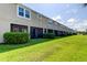 Tan townhouses with screened porches and lush landscaping at 2313 Sunset Wind Loop, Oldsmar, FL 34677