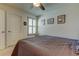 Bedroom with ceiling fan, gray bedding, and plantation shutters at 2313 Sunset Wind Loop, Oldsmar, FL 34677