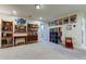 Bright home office featuring ample shelving and a large desk at 2313 Sunset Wind Loop, Oldsmar, FL 34677