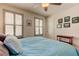 Spacious bedroom with light teal bedding and multiple windows at 2313 Sunset Wind Loop, Oldsmar, FL 34677