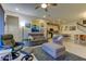 Open living room with comfortable seating, a large TV, and views to the kitchen at 2313 Sunset Wind Loop, Oldsmar, FL 34677