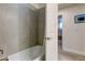 Bathroom with a tub and a gray tile shower surround at 2313 Sunset Wind Loop, Oldsmar, FL 34677