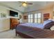 Main bedroom with a large TV and ample closet space at 2313 Sunset Wind Loop, Oldsmar, FL 34677