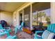 Outdoor patio with seating area and sliding glass doors at 2313 Sunset Wind Loop, Oldsmar, FL 34677