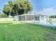 Spacious backyard with lush lawn and a glistening pool at 161 Overbrook W St, Largo, FL 33770