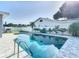 Refreshing pool with gray stone deck and backyard view at 161 Overbrook W St, Largo, FL 33770