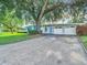 Spacious lot with mature trees and a mid-century modern home at 161 Overbrook W St, Largo, FL 33770