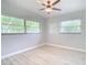 Spacious bedroom with light grey walls and ceiling fan at 161 Overbrook W St, Largo, FL 33770