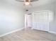 Bedroom with white louvered closet doors and ceiling fan at 161 Overbrook W St, Largo, FL 33770