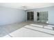 Screened porch with light flooring and access to the pool and kitchen at 161 Overbrook W St, Largo, FL 33770