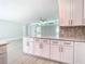 Modern white kitchen with stainless steel appliances and geometric backsplash at 161 Overbrook W St, Largo, FL 33770