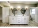 Double vanity bathroom with updated fixtures and stylish mirrors at 161 Overbrook W St, Largo, FL 33770