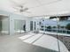 Spacious screened-in porch with pool access and ceiling fan at 161 Overbrook W St, Largo, FL 33770