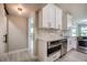 Modern kitchen with white cabinets, geometric backsplash, and stainless steel appliances at 161 Overbrook W St, Largo, FL 33770