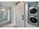 Laundry room with stacked washer and dryer and barn door at 161 Overbrook W St, Largo, FL 33770