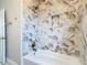 Bathroom with hexagon-tiled bathtub and shower area at 161 Overbrook W St, Largo, FL 33770