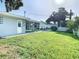 Expansive grassy backyard leading to a house and pool at 161 Overbrook W St, Largo, FL 33770