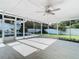 Bright screened porch with wood-look flooring and pool view at 161 Overbrook W St, Largo, FL 33770