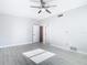 Bright bedroom with ceiling fan and light wood flooring at 161 Overbrook W St, Largo, FL 33770