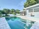 Inviting kidney-shaped pool with gray stone deck at 161 Overbrook W St, Largo, FL 33770
