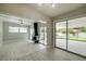 Living room with wood-look floors, fireplace, and sliding glass doors to backyard at 161 Overbrook W St, Largo, FL 33770