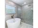 Spa-like bathroom with free-standing tub and walk-in shower at 161 Overbrook W St, Largo, FL 33770